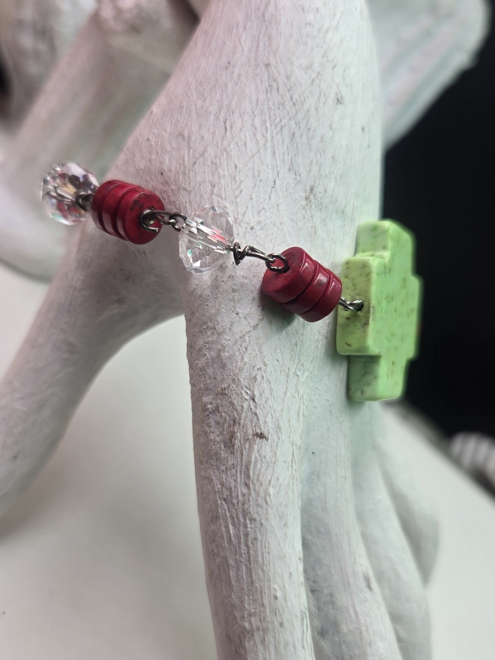 green cross-shaped bead, often fashioned from natural stone Bracelet